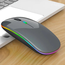 Gray computer mouse with RGB lighting on a wooden desk