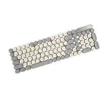 Acupressure mat with gray and beige stones on a white background