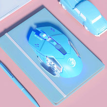 Blue gaming mouse on a pink and blue gradient surface