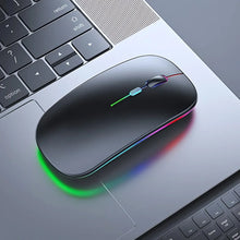 Black wireless mouse with RGB lighting on a laptop keyboard